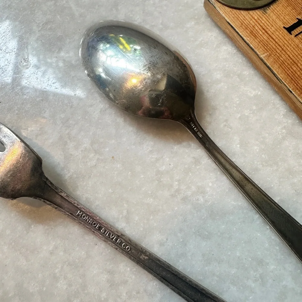 Small silverplate utensils.